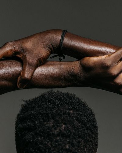 Close-up of a person's hands in a mindful yoga gesture.